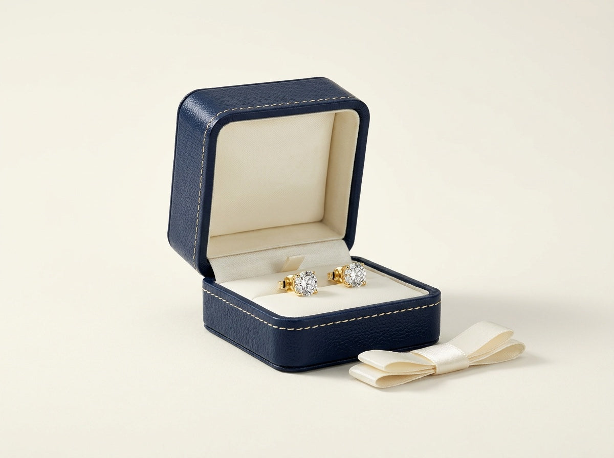 The Jasmine box — navy leather jewellery box with diamond studs and cream ribbon