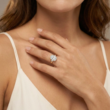Cyclamen Solitaire Ring worn — cushion-cut diamond, V-prongs, plain gold band