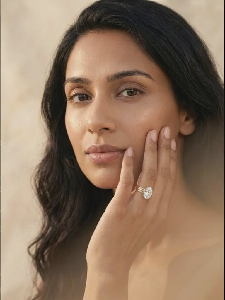 petunia-solitaire-ring worn by model, she lowers her lashes then looks up as the stone catches the light