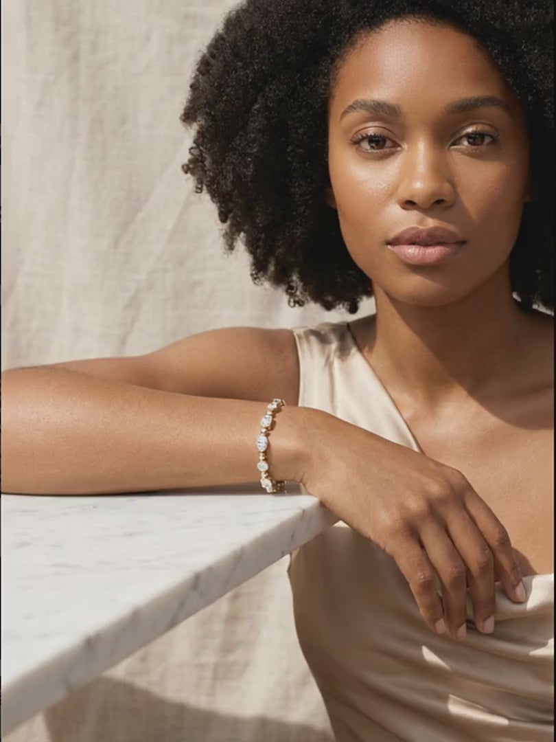 rosemary-tennis-bracelet worn by model, her draped wrist shifts slightly so the tennis bracelet catches the light